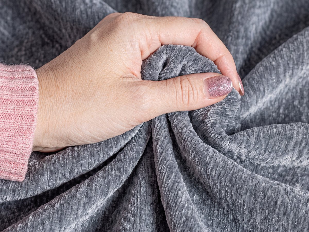 Hand gripping CouchCare DuraGrip chenille fabric